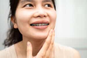 a young lady smiling with metal braces